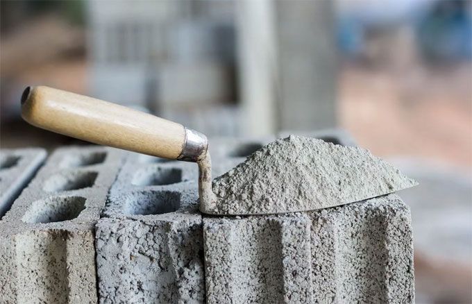 a close up of a cement block with a rolling pin sticking out of the top