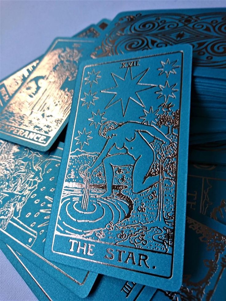 the star tarot cards are stacked on top of each other in blue and gold