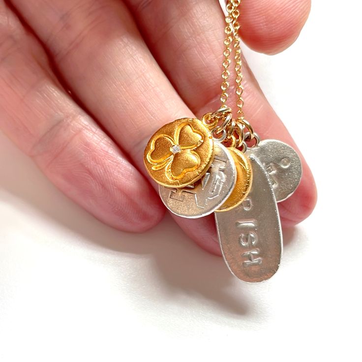 Build your own beautiful Notre Dame charm necklace from an assortment of 24k gold vermeil charms. All charms are hand made and no two are the same. Some charms may have crystals. Charms shown in silver and gold vermeil. How to design your necklace: 1) choose the number of charms you would like 2) enter the names of the charms in the boxes. Please use the following charm descriptions: Shamrock / ND / Number / Irish / Cross If you would like your player number, please just enter the number in the Gold Sterling Silver Pendant Charm Necklace, Gold Necklaces With Dangling Charms For Gifts, Yellow Gold Charm Necklaces With Dangling Charms For Gift, Handmade Yellow Gold Charm Necklaces Fine Jewelry, Yellow Gold Charm Necklace With Dangling Charms For Gift, Handmade Gold Charms For Everyday Wear, Handmade Gold Charms For Everyday, Personalized Amulet Necklaces For Anniversary, Handmade Yellow Gold Charm Necklace With Round Pendant