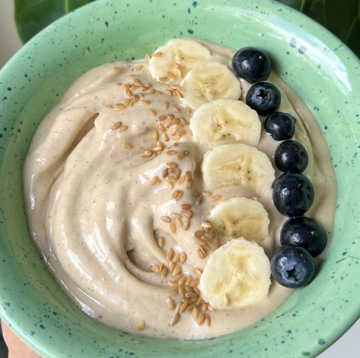 a bowl filled with oatmeal, bananas and blueberries