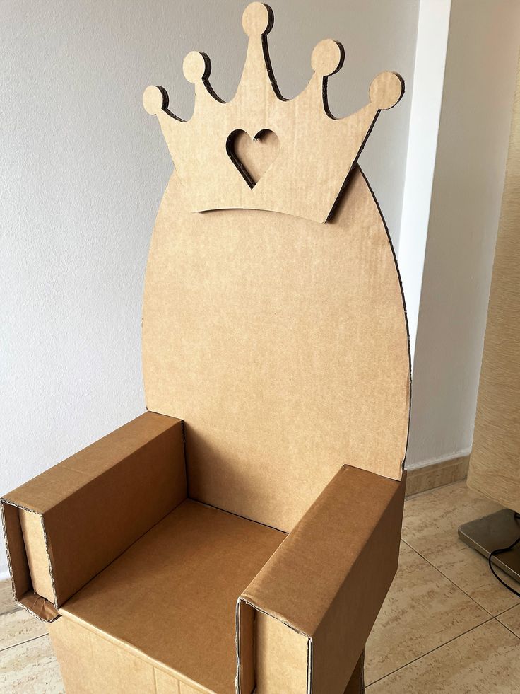 a cardboard chair made to look like a crown