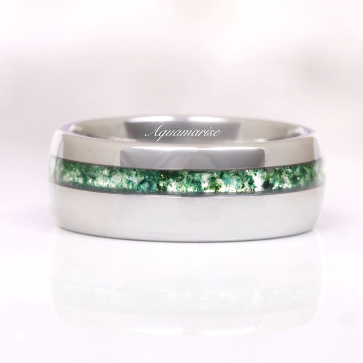 Green Moss Agate Men's Wedding Band - a testament to the timeless union of natural elegance and modern craftsmanship. This exquisite piece of jewelry seamlessly blends the rugged beauty of nature with the durability of contemporary materials, making it the perfect symbol of your enduring love and commitment.►Crafted with precision and passion, this wedding band features a striking 8mm wide band made from lustrous silver tungsten. Tungsten is renowned for its strength and resilience, ensuring tha Elegant Tungsten Carbide Jewelry For Gift, Elegant Tungsten Carbide Jewelry As A Gift, Elegant Tungsten Carbide Wedding Jewelry, Modern Green Jewelry For Promise Occasion, Modern Silver Tungsten Carbide Jewelry, Minimalist Titanium Jewelry For Formal Occasions, Modern Stainless Steel Wedding Jewelry, Round Tungsten Carbide Jewelry Gift, Modern Jewelry With Polished Edges For Wedding