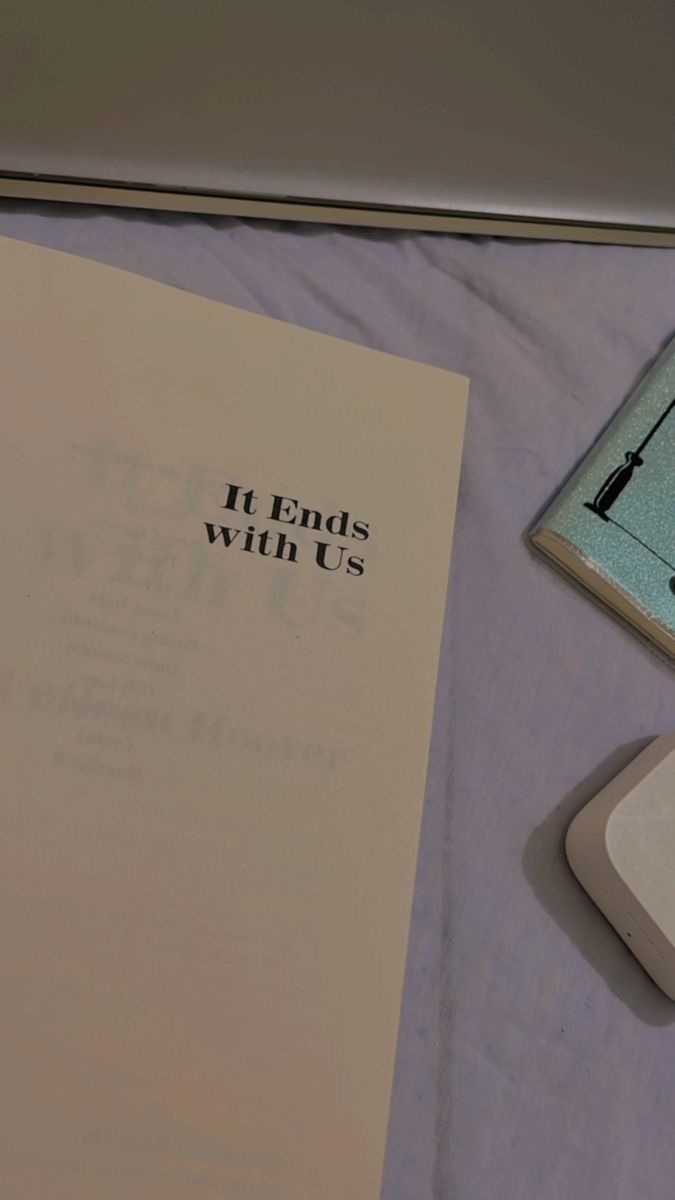 an open book sitting on top of a table next to a computer mouse and keyboard