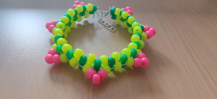 a bracelet made out of plastic beads on a table