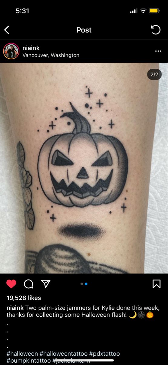 a black and white photo of a pumpkin tattoo on someone's leg, with the words halloween written below it