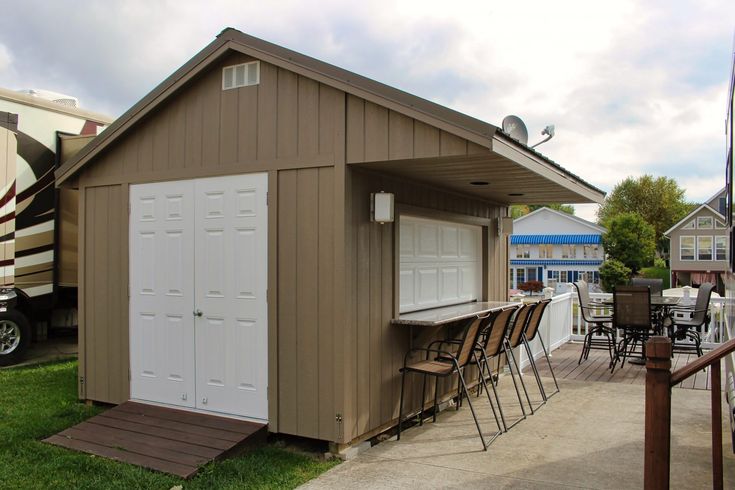 a small shed with chairs and tables outside