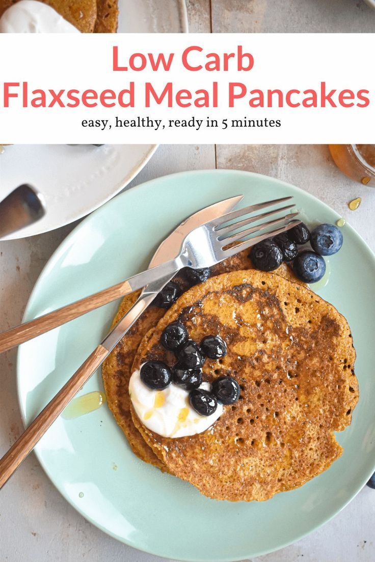 a stack of pancakes with blueberries and whipped cream on top, sitting on a plate