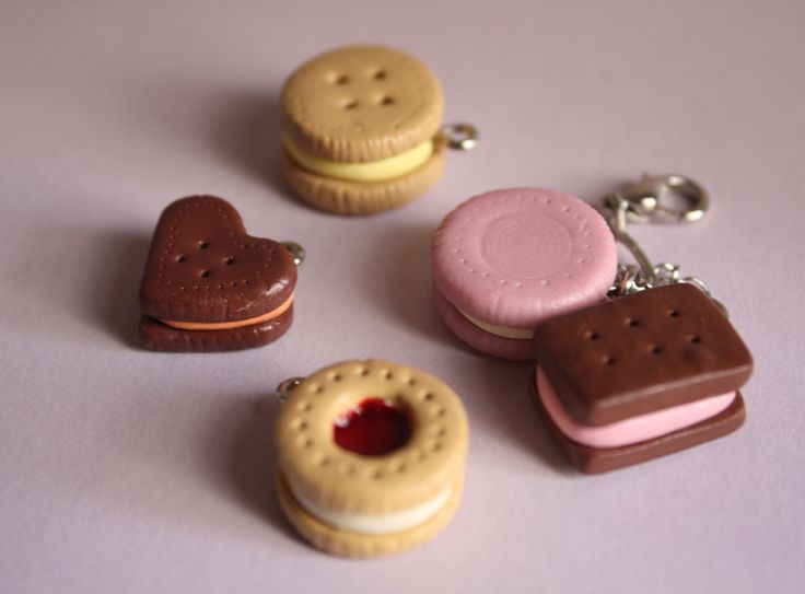 three cookies and two heart shaped biscuits on a white surface