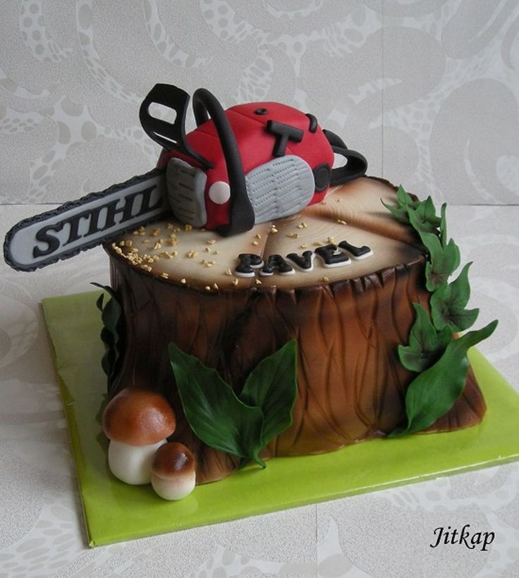 a cake made to look like a tree stump with a chainsaw on top