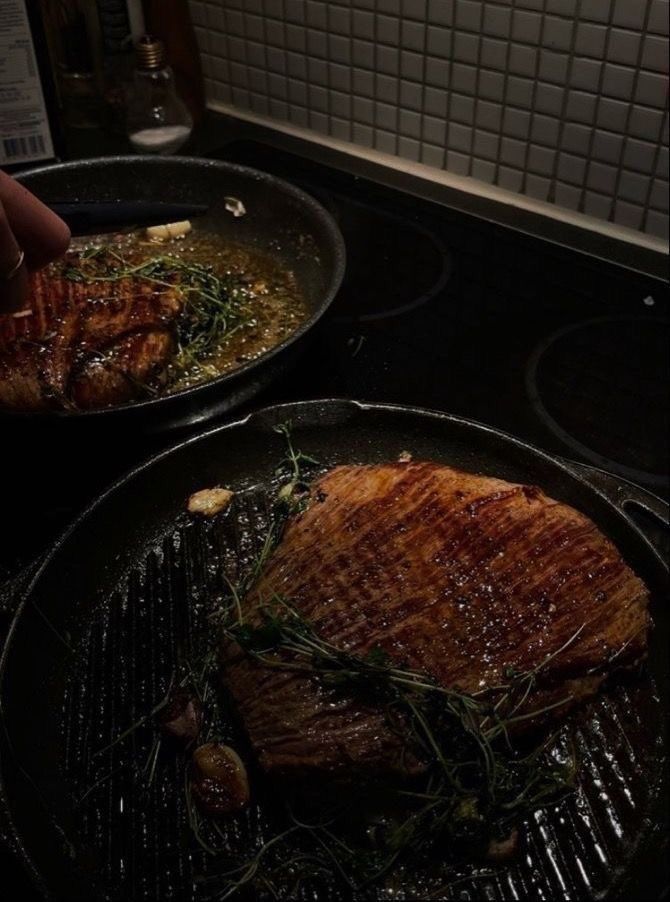 two pans filled with food cooking on top of a stove