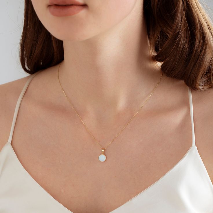 "Oval White Opal Solitaire Necklace, 10K and 14K Solid Gold Bridal Necklace, Bridesmaid Necklace, OpalNecklace, Cute Necklace, Girlfriend Necklace, Delicate Necklace  ⚪MATERIAL We manufacture our products from 10K and 14K solid gold. ⚪This is a very elegant and beautiful White Opal necklace with a lab-created oval-shaped opal, great iridescence, and sheen, with one diamond simulant on top. ⚪In the Middle Ages, Opal was considered a stone that could provide great luck because it was believed to possess all the virtues of each gemstone whose color was represented in the color spectrum of the opal. ⚪Classic Oval shape cute necklace with chain, which perfectly matched any occasion. Wearing this special Opal necklace could be a protection amulet to ward off misfortune. Necklaces can bring good White Round Necklace With Adjustable Chain, Delicate Round White Necklace, Dainty White Round Necklace, White Necklace With Delicate Chain, White Round Dainty Necklace, Minimalist White Round Necklace, Formal White Charm Necklace With Clavicle Chain, Delicate White Round Jewelry, White Diamond Necklace With Delicate Chain