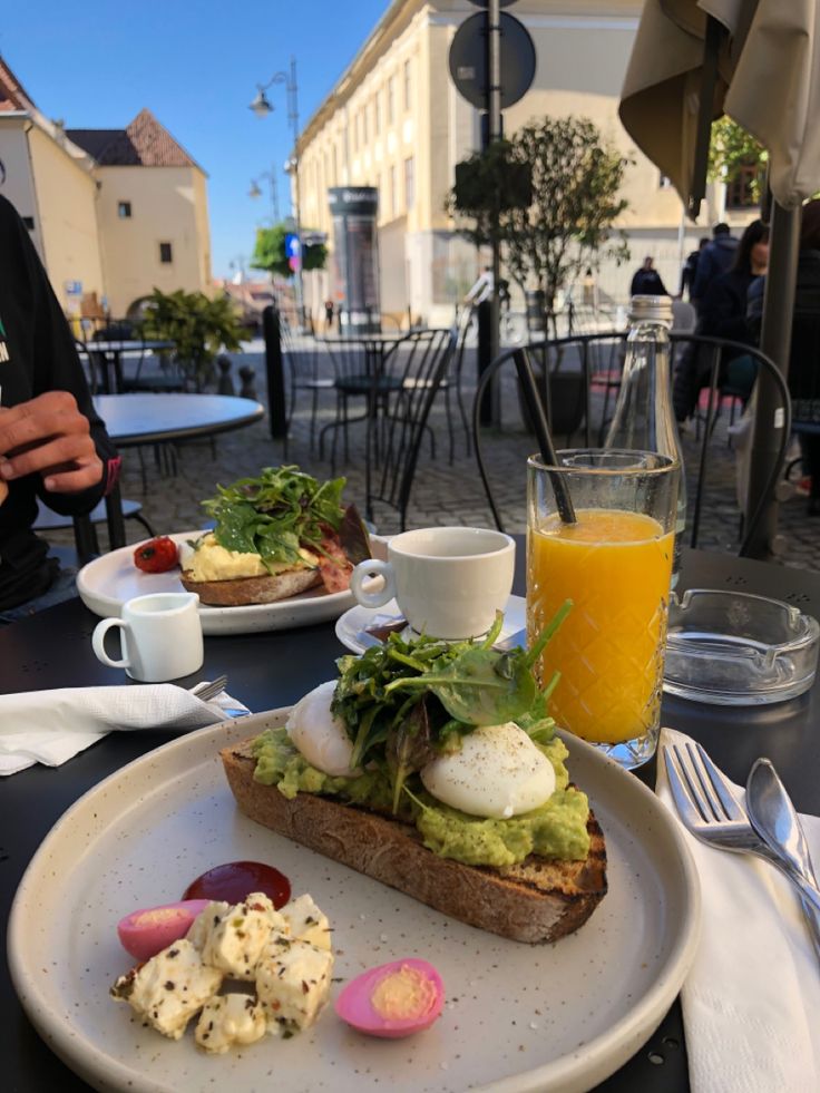 a white plate topped with an open face sandwich