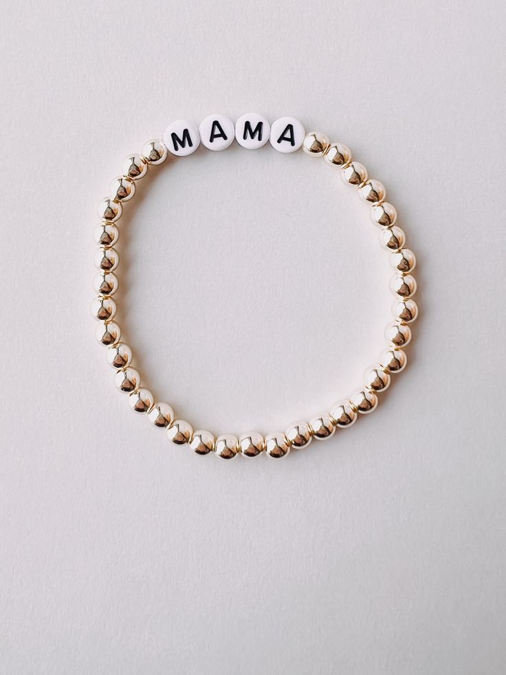 Meet our new Gold Beaded Mama Bracelet! Perfect for embracing motherhood in style! Great gift for moms and mom figures in your life! Everyday Beaded Sterling Silver Bracelets, Everyday Sterling Silver Beaded Bracelets, Elegant Handmade Name Bracelet With Round Beads, Personalized Bracelets As Gift For Mom, Jubilee Bracelet For Mother's Day, Elegant Beaded Bracelets With Letter Beads For Gift, Adjustable Name Bracelet As Gift For Mom, Elegant Beaded Bracelets With Letter Beads As Gift, Spiritual Jubilee Beaded Bracelets