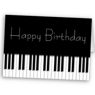 a happy birthday card with piano keys