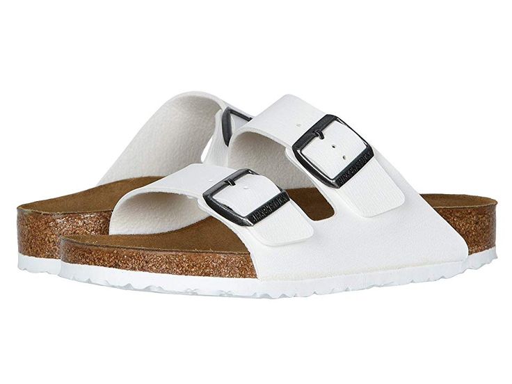 a pair of white sandals with two buckles