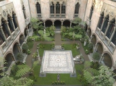 an aerial view of a courtyard with many trees and plants in the center, surrounded by stone arches