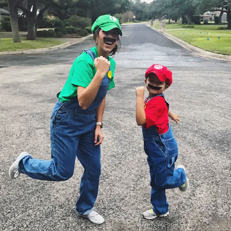 a man and boy are running in the street