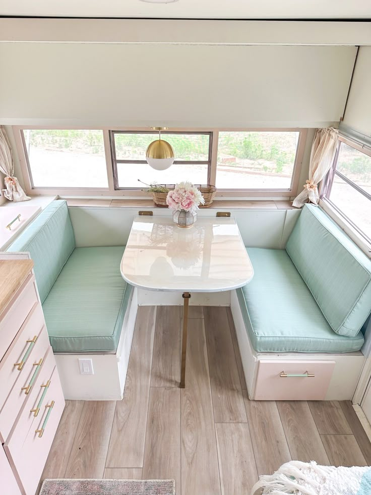 the interior of a mobile home with a kitchen and dining room table in front of it