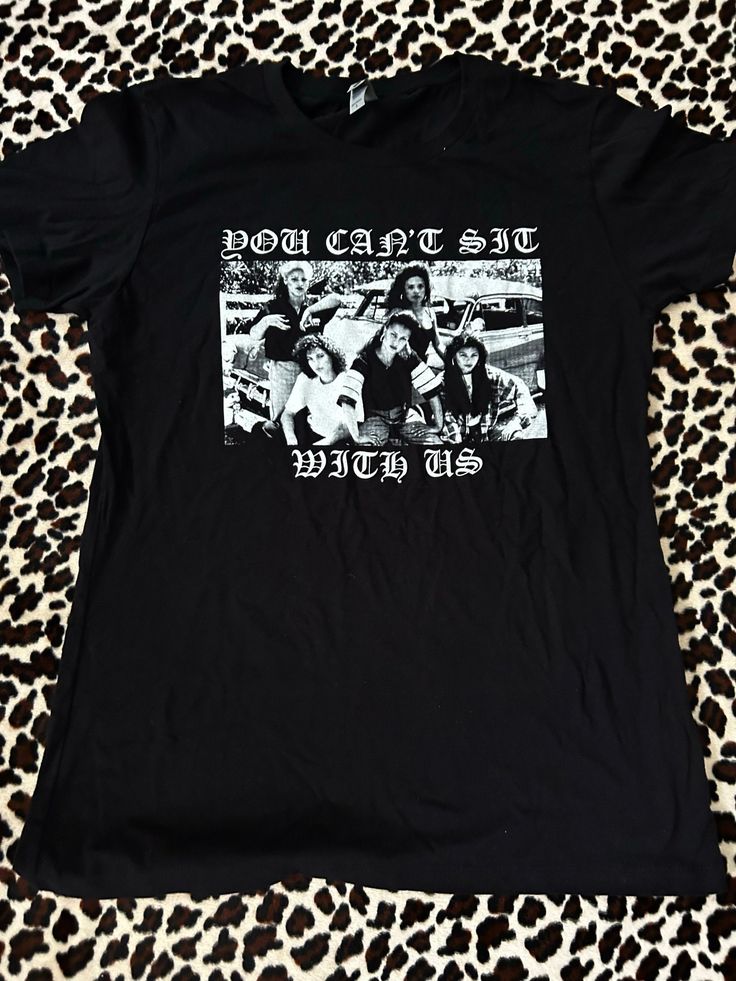 a black t - shirt with an image of people on it