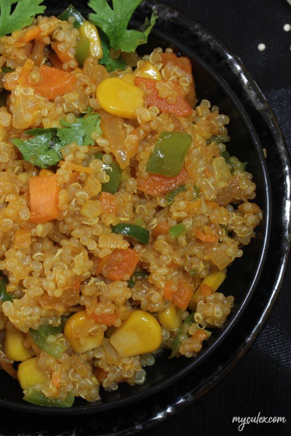 a black bowl filled with rice and vegetables