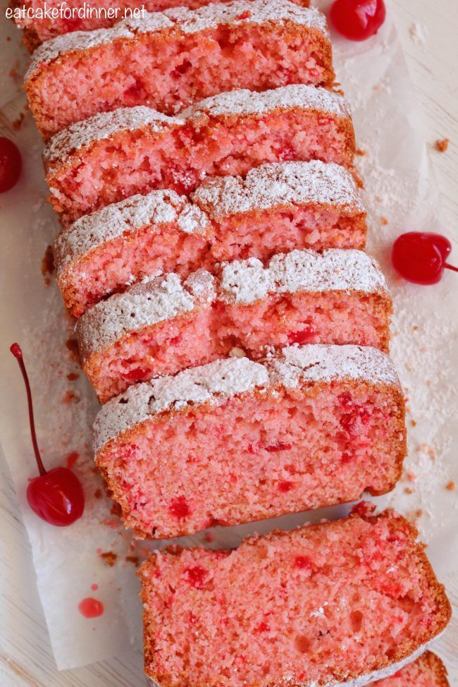 slices of cake with powdered sugar and cherries on top