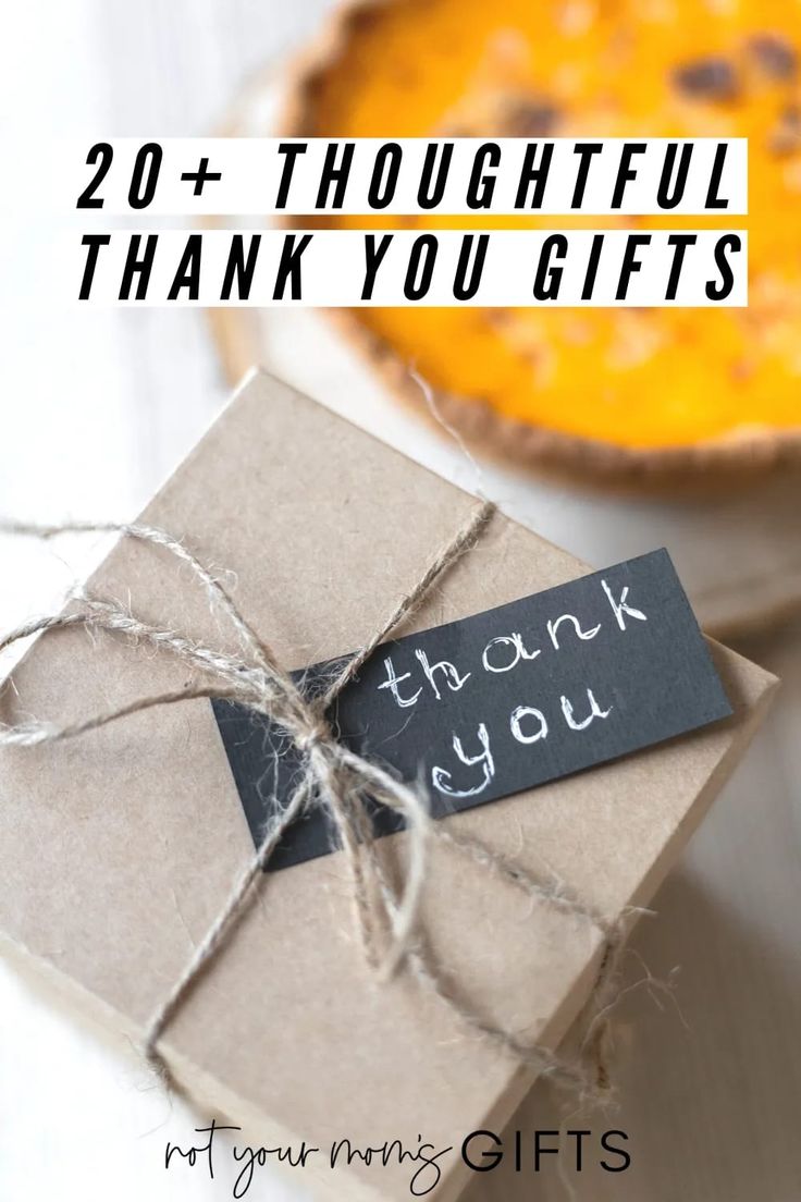 a gift wrapped in brown paper with the words thank you written on it next to an orange pie