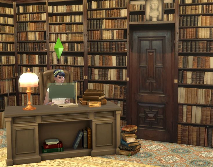 a computer sitting on top of a desk in front of a book shelf filled with books