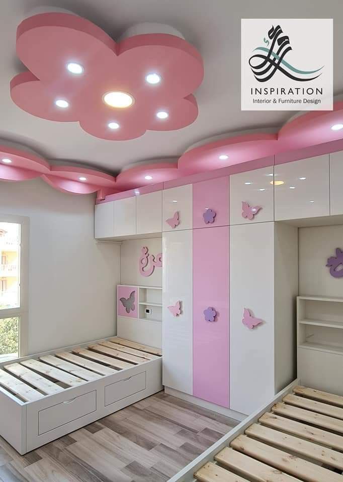 a bedroom with pink and white decor on the ceiling