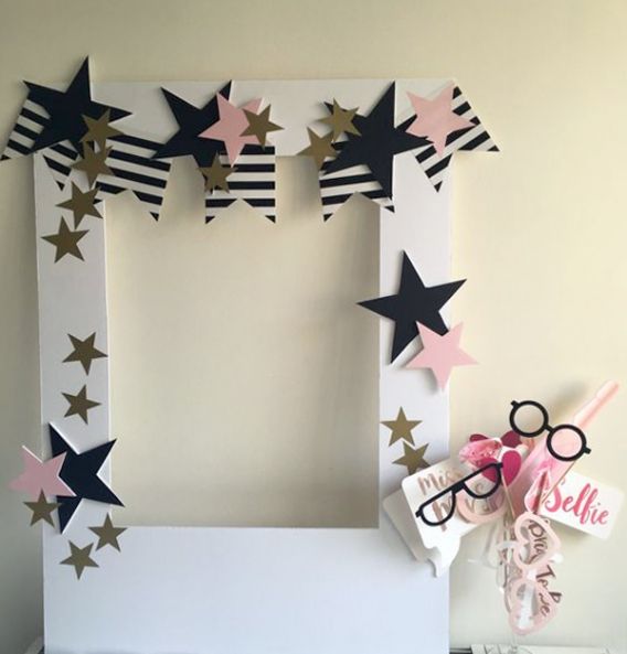 a photo frame made out of paper with stars on it and some decorations around the edges