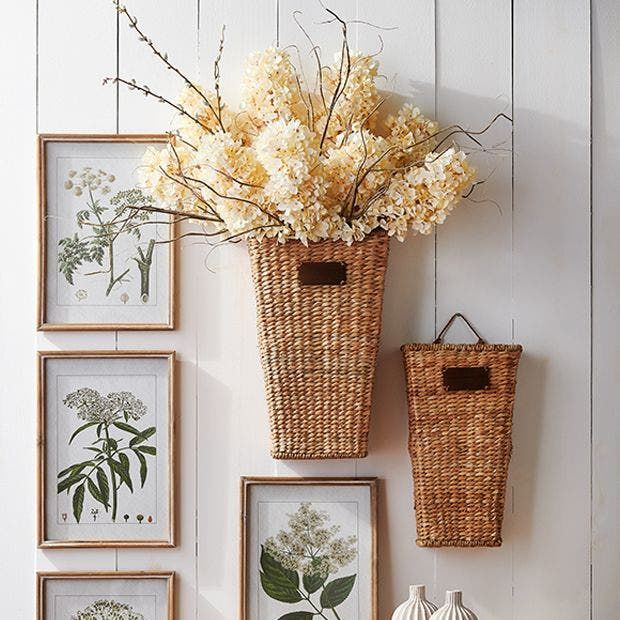 some pictures hanging on the wall with vases and flowers in them next to baskets