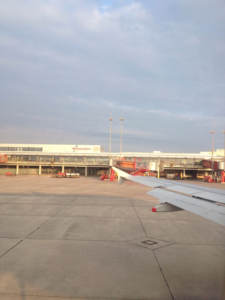 an airplane wing sitting on top of an airport tarmac