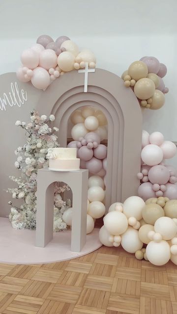 a room decorated with balloons and decorations for a christ baby shower or birthday party in pastel colors