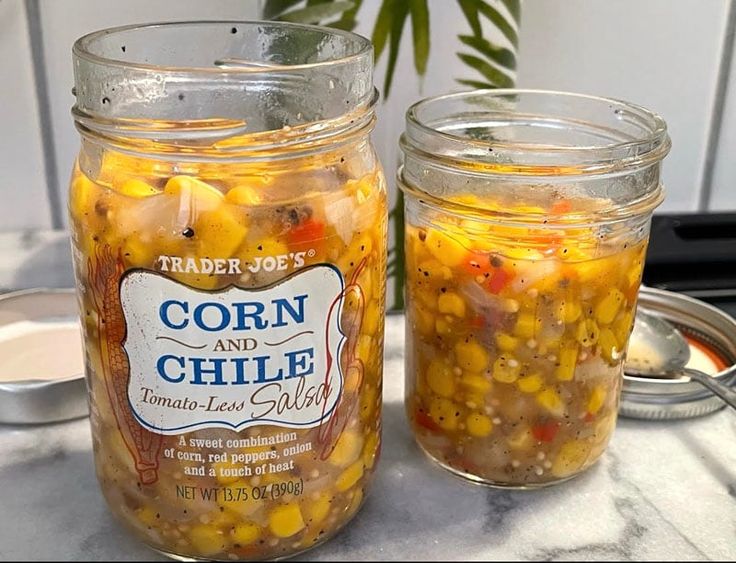 two jars filled with food sitting on top of a table