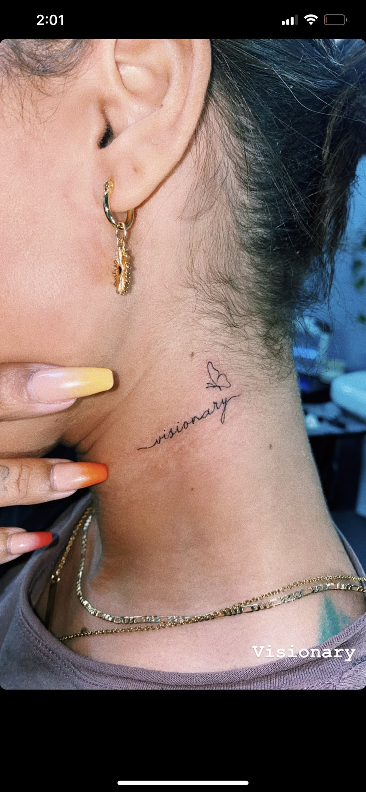 a woman with a small tattoo on her neck