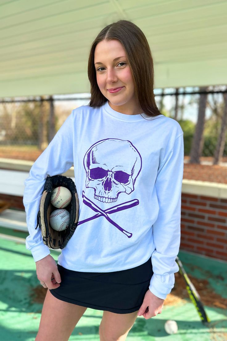 Show off your team spirit with our Skull and Bats Tee Long Sleeve! This white long sleeve t-shirt is perfect for comfort and style. With a purple skull and baseball bats screen printed on the front, you'll be the ultimate fan of the East Carolina Pirate baseball team. Go Pirates! Model is wearing a size small. Stocked at Arlington Village and Uptown. Purple Skull, Pirates Baseball, Baseball Bats, East Carolina Pirates, Baseball Team, The East, Team Spirit, White Long Sleeve, Long Sleeve T Shirt