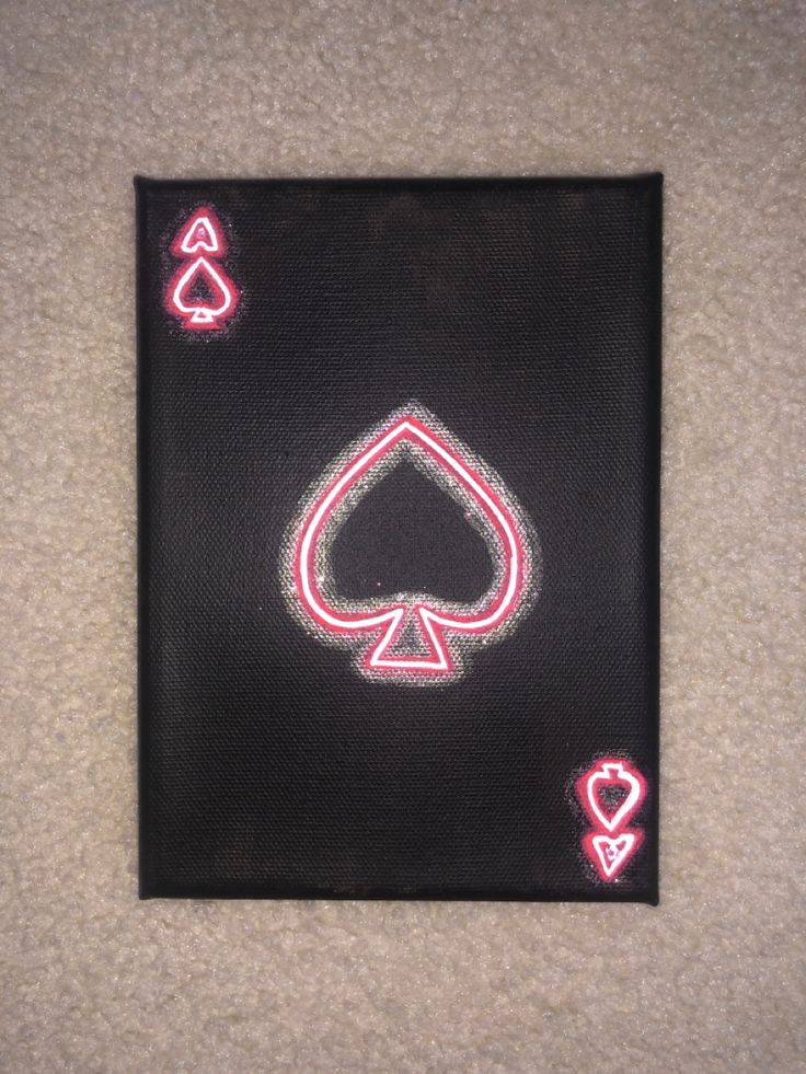 a playing card with neon lights in the shape of hearts and spades on it