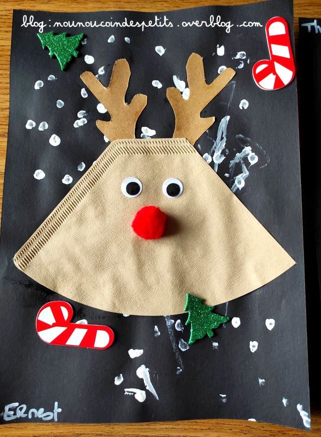 a paper bag with a reindeer face and candy canes