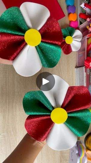 two red, white and green hair bows on top of each other