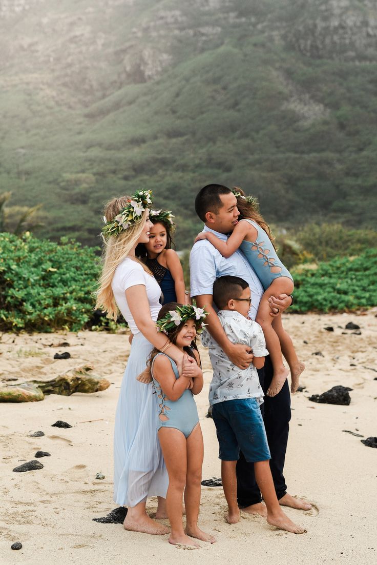 a family posing for a photo on the beach