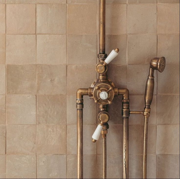 two old fashioned faucets are attached to the wall