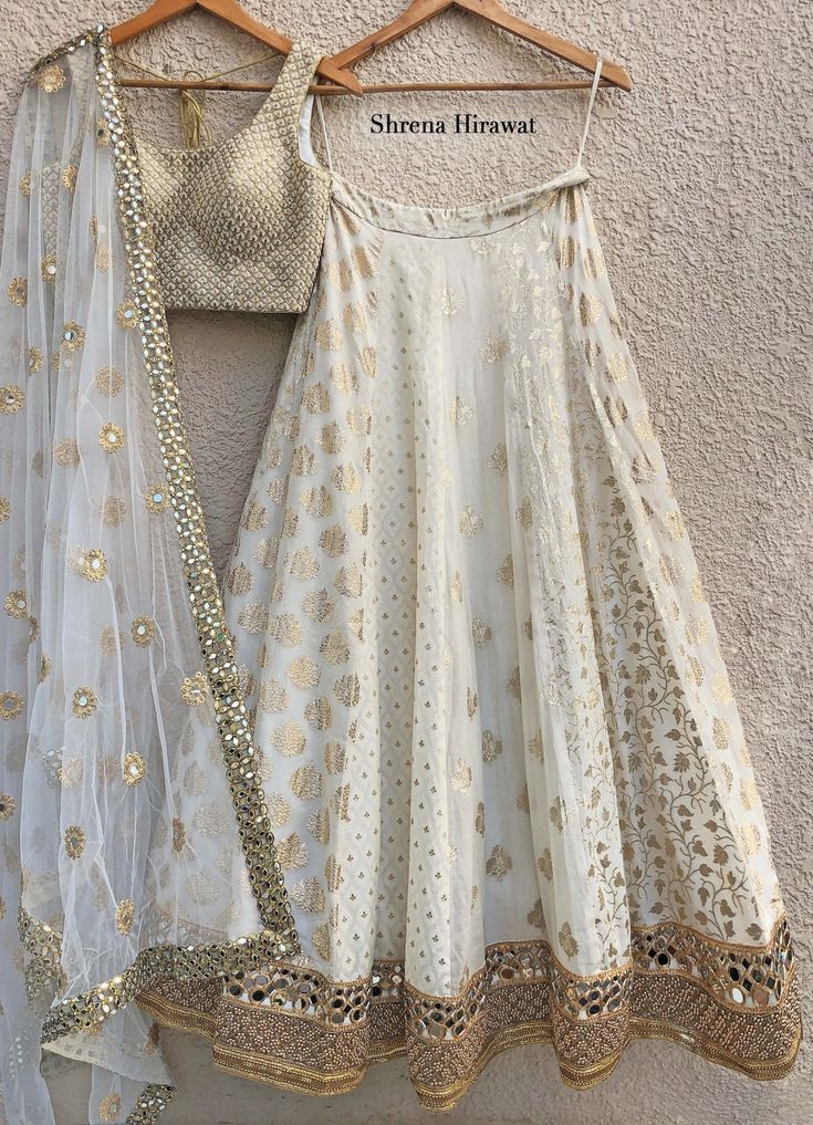 White and Gold Threadwork Blouse With Ivory Kali Lehenga And Net Dupatta Shrena Hirawat - Fabilicious Fashion Luxury White Choli With Cutdana, Luxury White Georgette Lehenga, Luxury White Choli With Dori Work, Luxury White Blouse For Navratri, Luxury Chanderi Choli For Diwali, Luxury White Chinon Choli, Luxury Off-white Sharara For Navratri, Luxury Semi-stitched Bohemian Choli, Luxury Off White Traditional Wear With Mirror Work