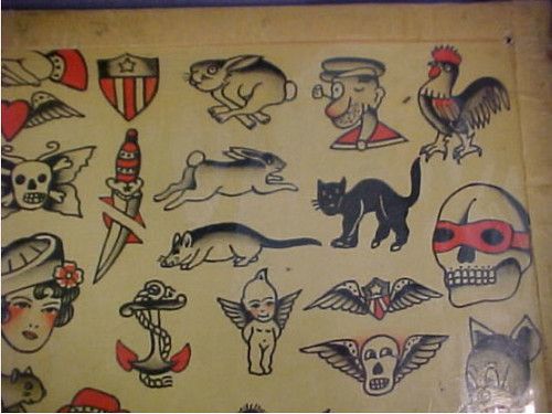 an old poster with many different tattoos on it's back wall, including cats and dogs