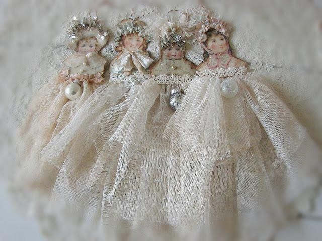 three little dolls are dressed in white dresses and tiaras, with pearls on them