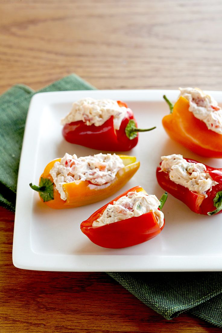 several stuffed peppers are on a white plate