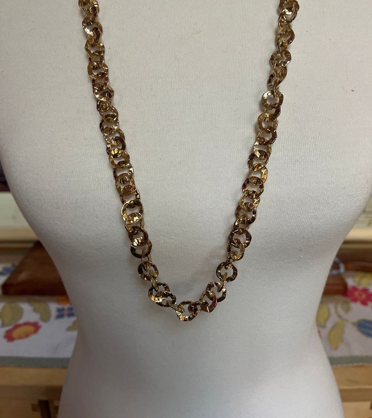 This listing is for a long gold-tone circular chain link necklace. This necklace has a beautiful shine to it, which makes me wonder if it is gold-plated. There are no markings. It is 32" long with an extra 2 1/2" extension chain. The discs are about 1/2" in diameter. A perfect necklace for the holidays! The shipping weight will be 3 ounces. Formal Gold Necklace With Chain Strap, Formal Gold-tone Long Necklace With Chain, Gold Long Necklace With Adjustable Chain For Party, Gold Metal Long Necklace, Gold Chunky Chain Long Necklace, Gold Oval Link Chain Necklace For Party, Gold Link Chain Necklace For Party, Gold Long Necklace With Metal Chain Style, Gold-tone Long Metal Chain Necklace