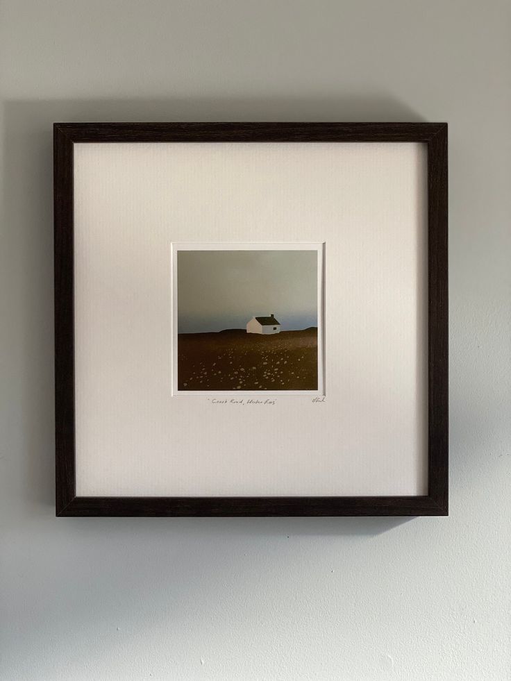 a framed photograph hanging on the wall