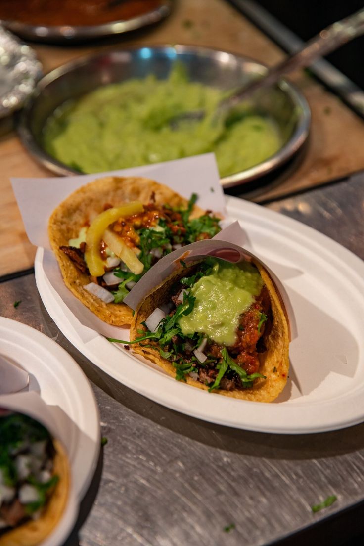 two plates with food on them sitting on a table