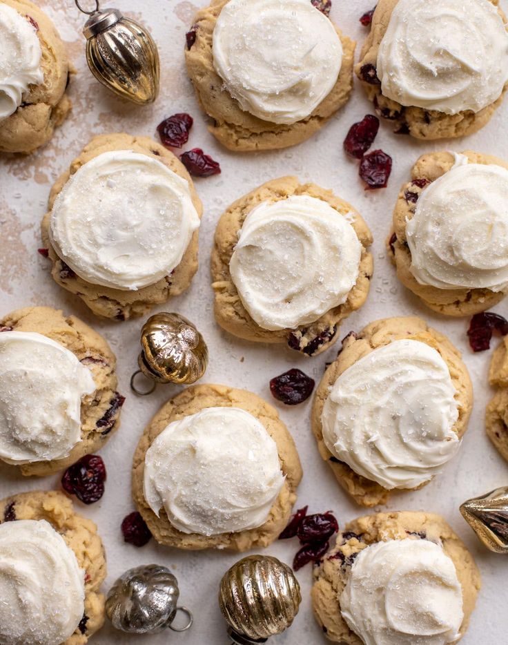 cookies with white frosting and cranberries on top