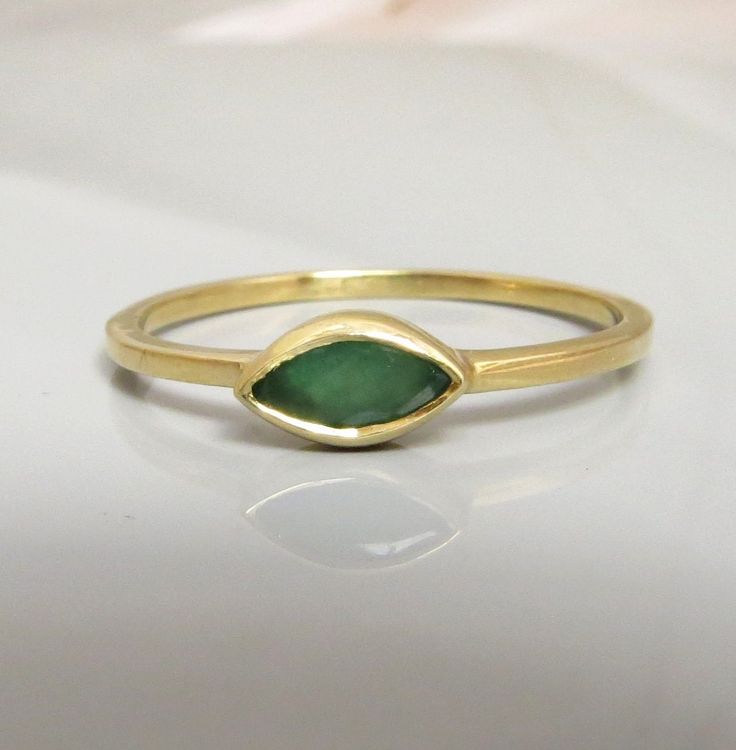 "This 14k solid gold delicate Emerald ring, features a marquise shaped green Emerald gemstone as a centerpiece. I made the ring by hand carving wax and creating the bezel especially for the gemstone, one piece with no soldering. The ring looks very gentle on the finger, yet the Emerald gemstone is beautifully visible, it is perfect for everyday as well as for special occasions, either by itself or stacked with another rings/s. You can wear this gold ring with another ring as seen in the pictures Emerald Gold Ring, Gold Ring Stacking, Blue Opal Ring, Green Emerald Ring, May Birthday, Marquise Ring, Opal Ring Gold, Solid Gold Ring, Etsy Gold Ring