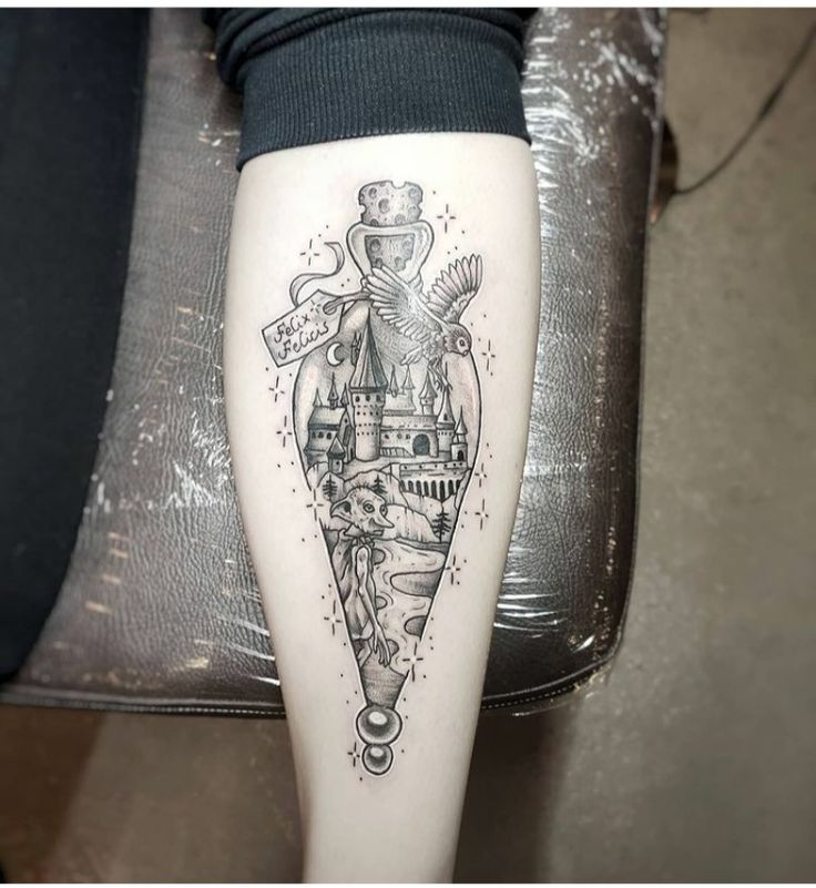 a woman's leg with a tattoo on it that has a castle in the middle